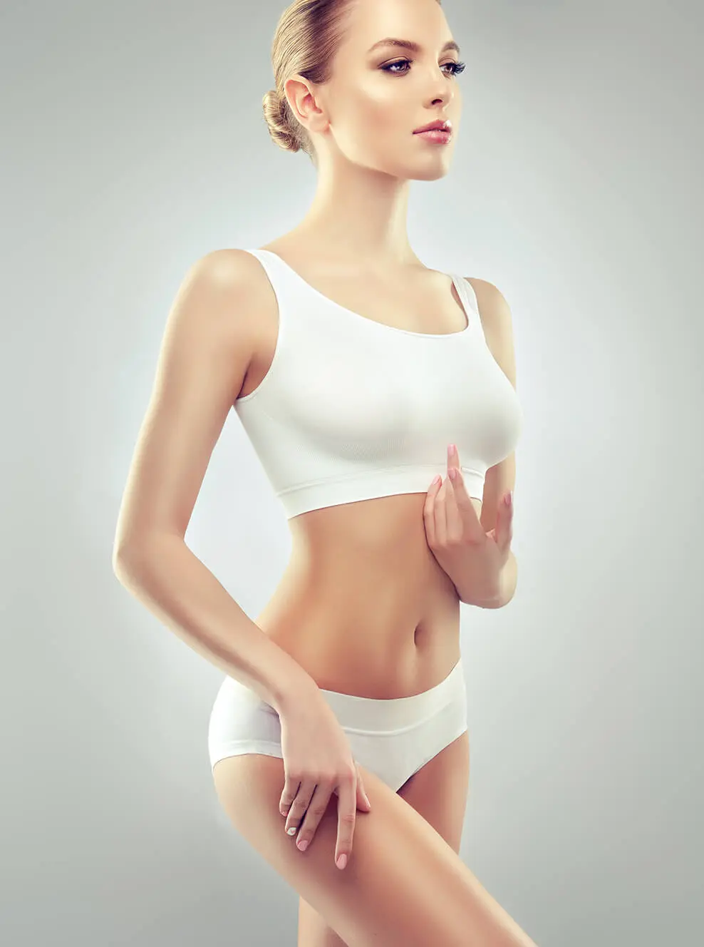 A woman in white underwear holding her hand up to the side.